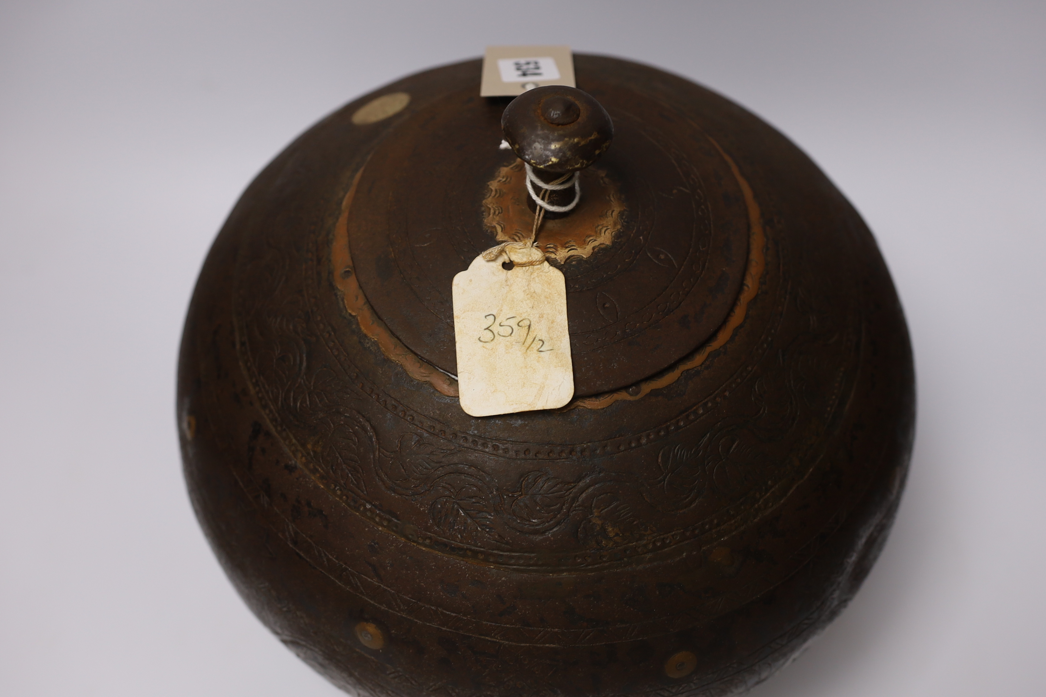 A metal etched eastern squat vase and cover, 32cm high
